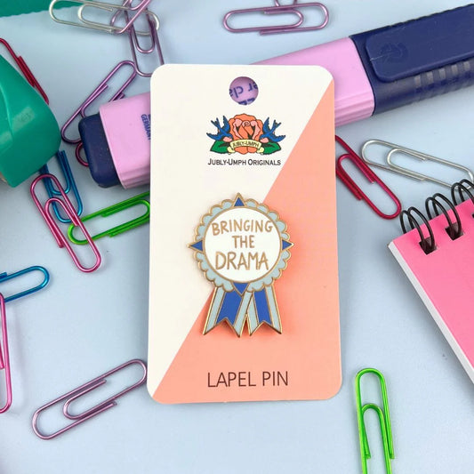 Jubly_Umph_Bringing_The_Drama_Lapel_Pin_in_packaging
