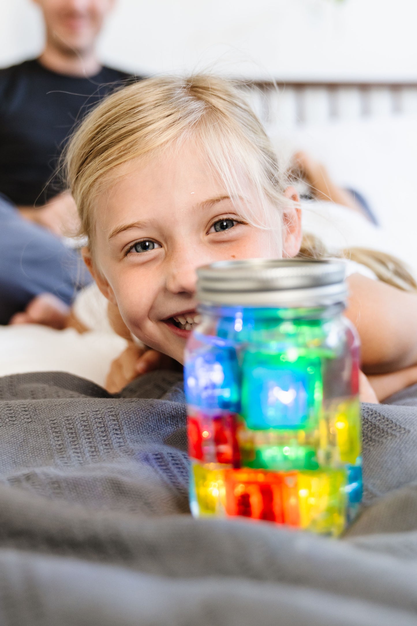 Jelly_stone_Girl_playing_with_jar_of_brightly_coloured_glo_pal_cubes