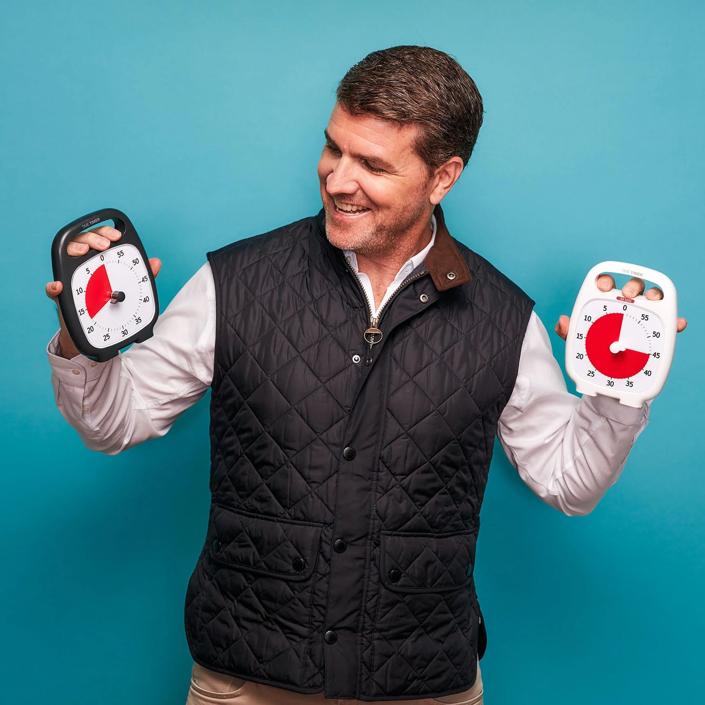 Time_Timer_Plus_visual_Timer_man_holding_both_White_and_black_timers