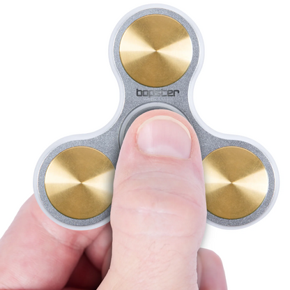 Fidget spinner with gold and silver design held by a finger on a white background. Brand- Bopster
