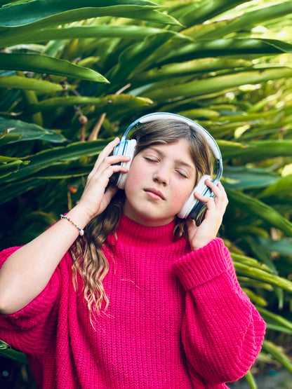 EMS_FOR_KIDS_Active_noise_cancelling_ear_phones_girl_wearing_a_pair_outside