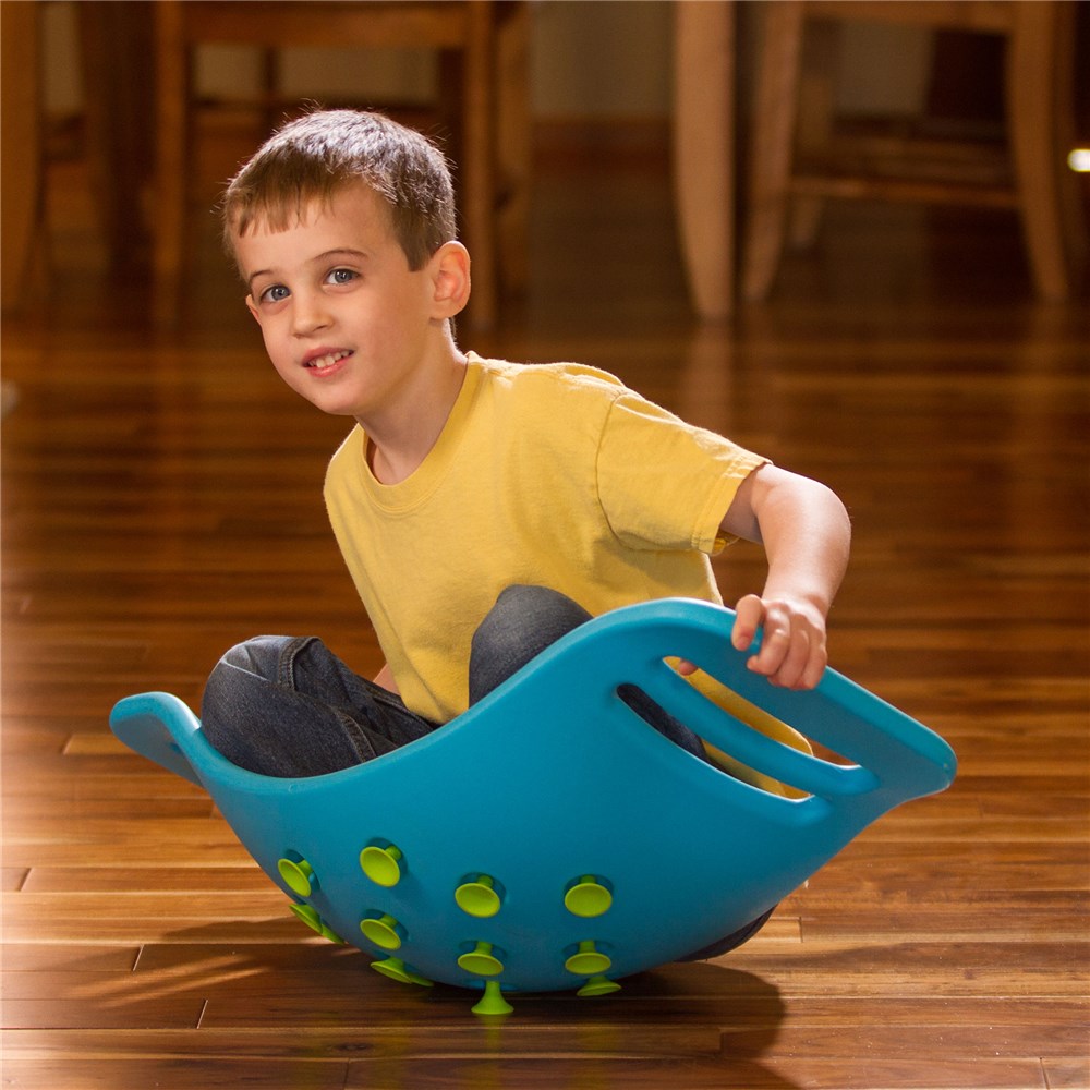 Fat_Brain_Toys_Teeter_Popper_Child_sitting_in_Blue_Teeter_Popper