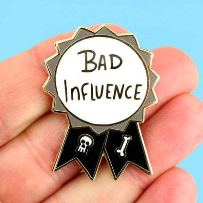 Jubly-Umph_Bad_influence_lapel_pin_on_persons_hand