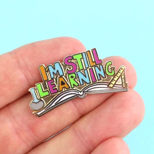 Jubly-Umph_I_m_still_learning_enamel_pin_on_persons_hand