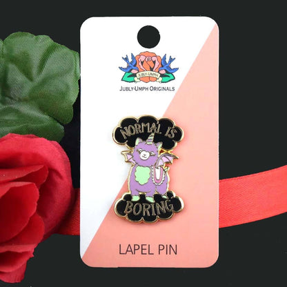 Jubly-Umph_Normal_Is_Boring_Lapel_Pin_on_cardboard_packaging