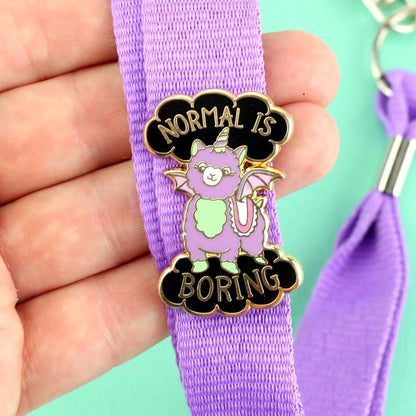 Jubly-Umph_Normal_Is_Boring_Lapel_Pin_on_purple_bag_strap