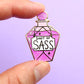 Jubly-Umph_Shot_of_Sass_lapel_pin_in_between_persons_fingers