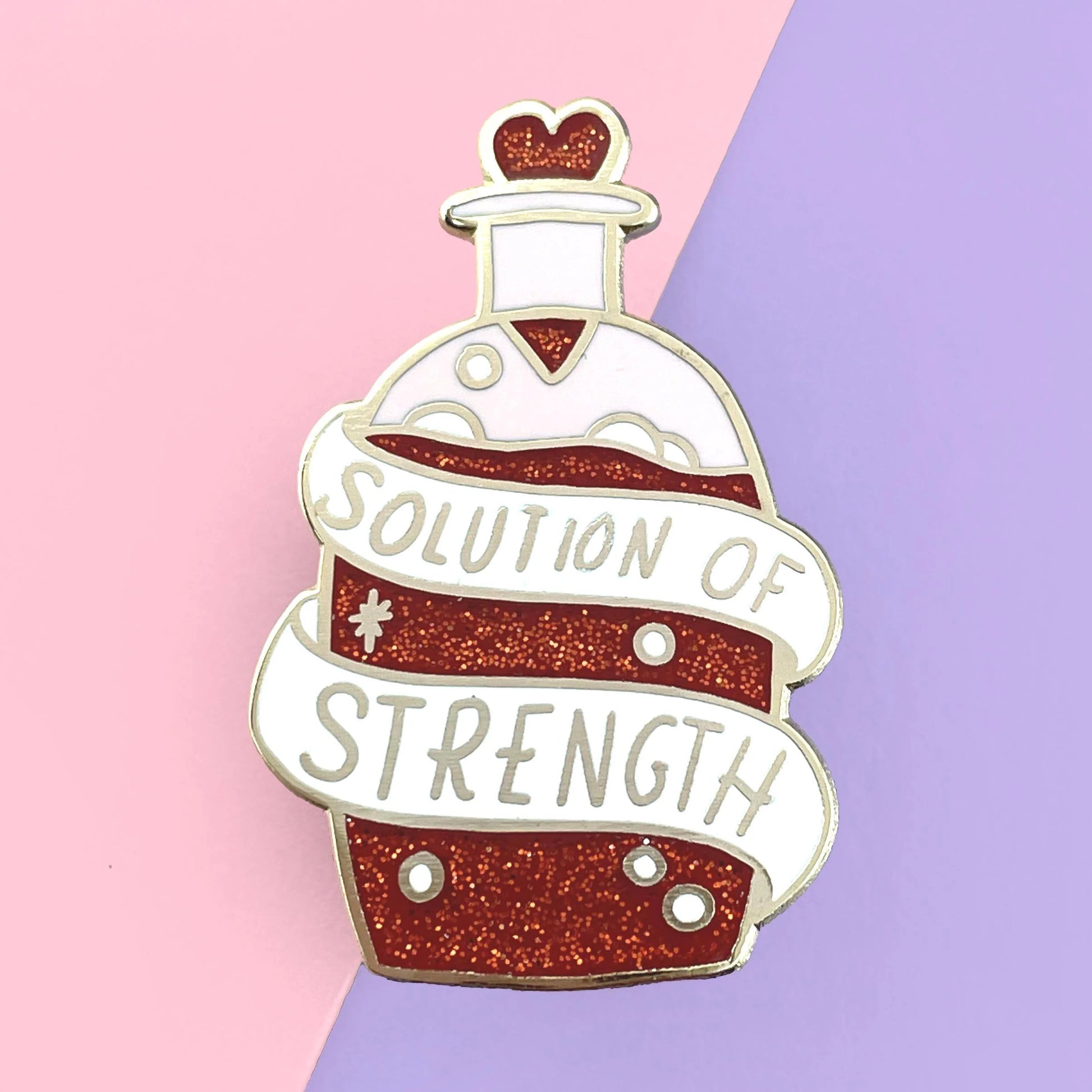 Jubly-Umph_Solution_of_strength_lapel_pin_on_oink_abd_purple_background