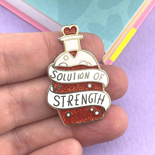 Jubly-Umph_Solution_of_strength_lapel_pin_on_personas_hand