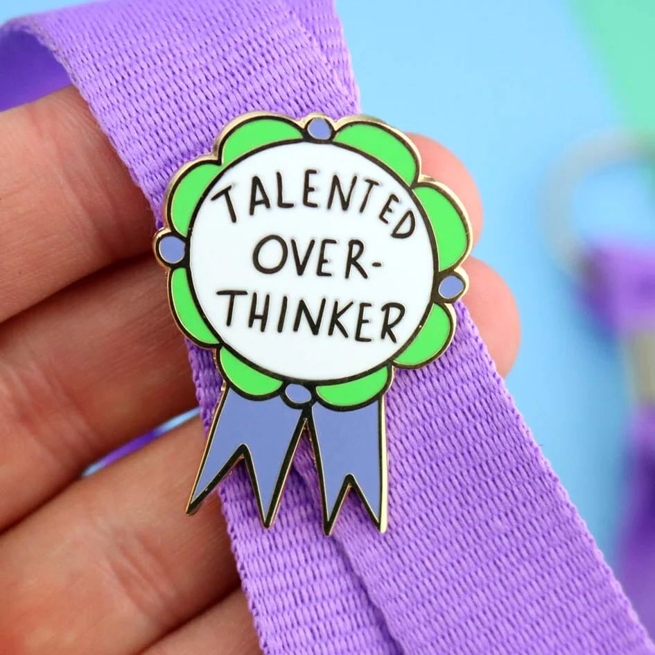Jubly-Umph_Talented_Over_Thinker_Lapel_Pin_Origional_on_purple_bag_strap