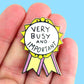 Jubly-Umph_Very_busy_and_important_Lapel_pin_on_persons_hand