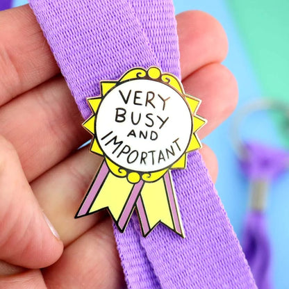 Jubly-Umph_Very_busy_and_important_Lapel_pin_on_purple_bag_strap