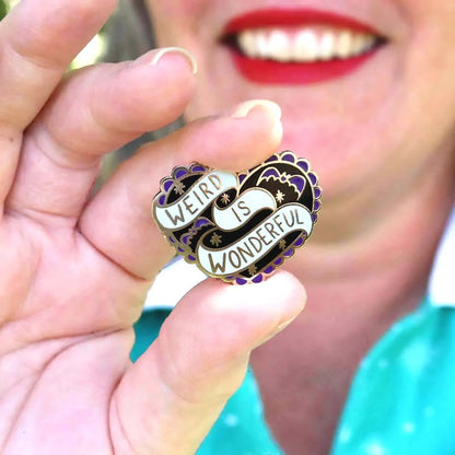Jubly-Umph_Weird_Is_Wonderful_Lapel_Pin_pinched_betweem_two_fingers