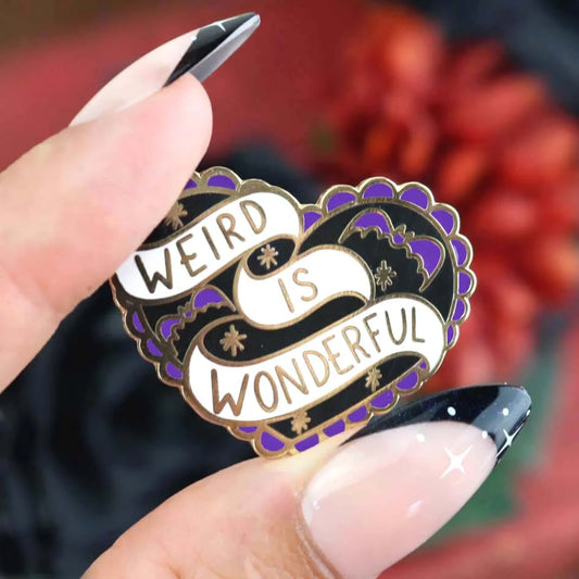Jubly-Umph_Weird_Is_Wonderful_Lapel_Pin_pinched_betweem_two_fingers_with_long_black_nails