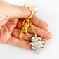 Jubly_Umph_KeyChain_Proudly_neuro_sparkly_in_hand