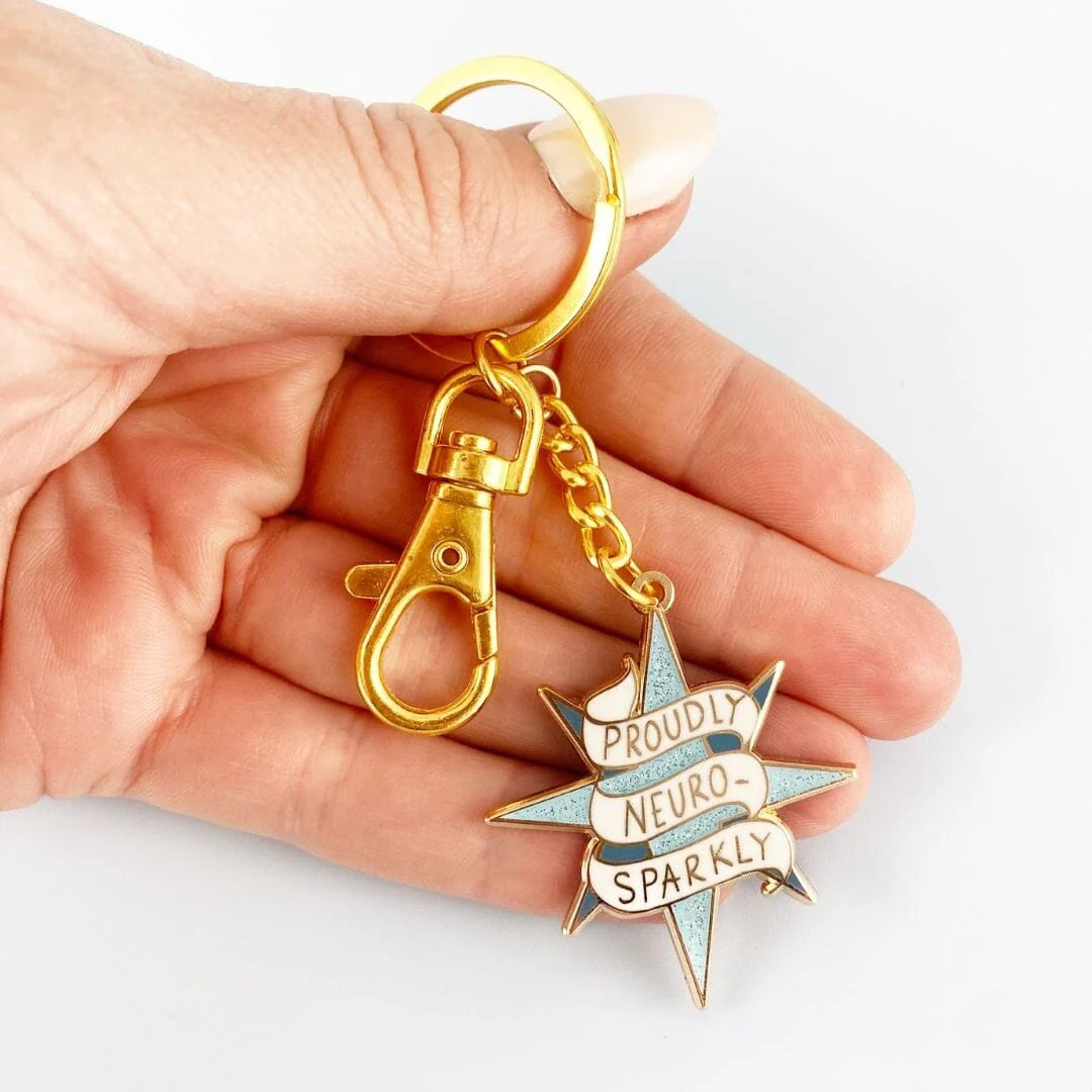 Jubly_Umph_KeyChain_Proudly_neuro_sparkly_in_hand