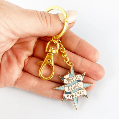 Jubly_Umph_KeyChain_Proudly_neuro_sparkly_in_hand