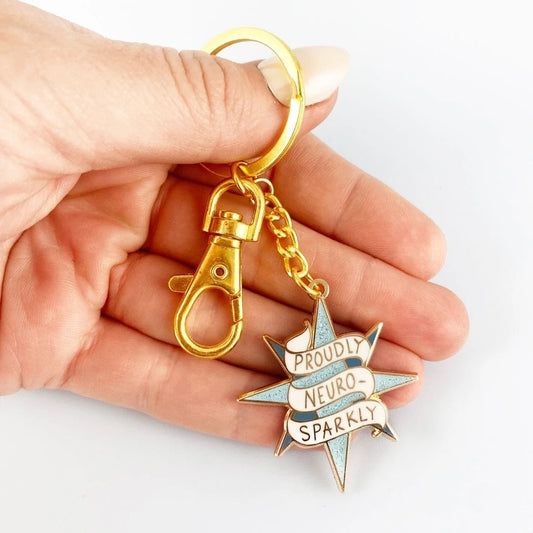 Jubly_Umph_KeyChain_Proudly_neuro_sparkly_in_hand