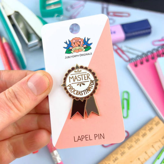 Jubly_Umph_Master_Procrastinator_-Lapel_Pin_in_packaging