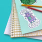 Jubly_Umph_Sticker_normal-is-boring_on_book