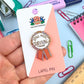 Jubly_Umph_Still_here_surviving_lapel_pin_on_packaging
