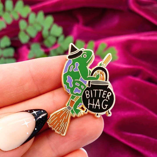 Jubly_Umph_bitter_hag_lapel_pin_in_hand