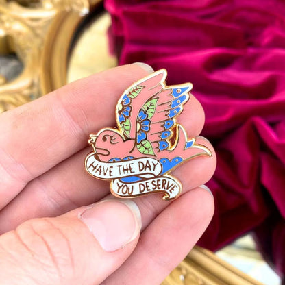 Jubly_Umph_have_the_day_you_deserve_lapel_pin_in_hand