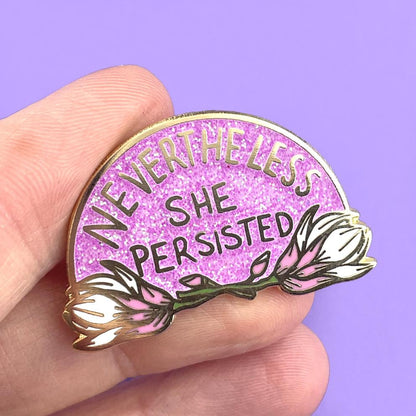 Jubly_Umph_never_the_less_she_persisted_lapel_pin_in_hand