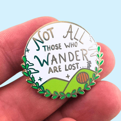 Jubly_Umph_not_all_who_wander_are_lost_enamel_pin_in_hand
