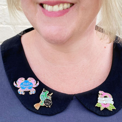 Jubly_Umph_not_demure_just_hostile_lapel_pin_person_wearing_pin