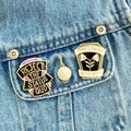 Three pins on a denim jacket