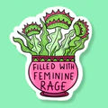 Sticker with text 'Filled with Feminine Rage' on a light green background
