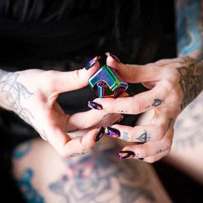 Kaiko_fidgets_oil_slick_spinning_cube_in_persons_hands