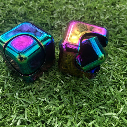 Kaiko_fidgets_oil_slick_spinning_cube_on_grass