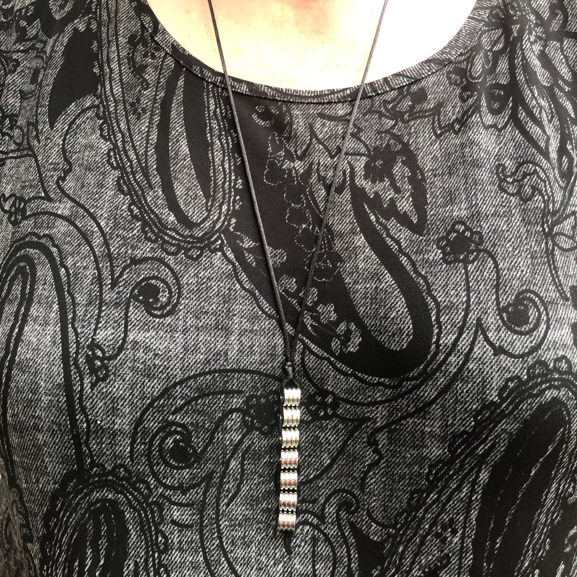 Kaiko_silk_worm_necklace_on_persons_neck