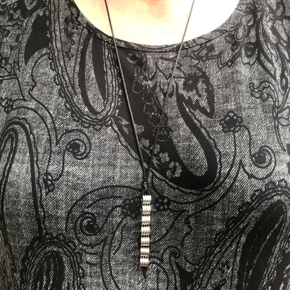 Kaiko_silk_worm_necklace_on_persons_neck
