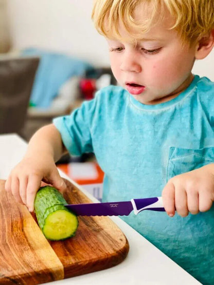 Kiddikutter_young_boy_cutting_cucumber_with_knife_purple