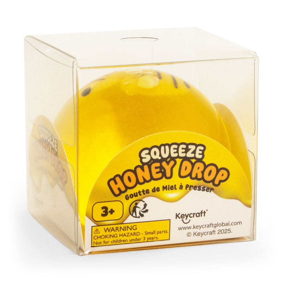 Yellow honey drop toy in clear packaging with Keycraft branding.SQUEEZE_HONEY_BEE_DROP_bee_packaging