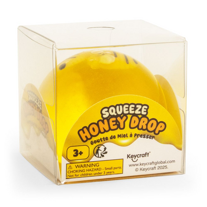 Yellow honey drop toy in clear packaging with Keycraft branding.SQUEEZE_HONEY_BEE_DROP_bee_packaging