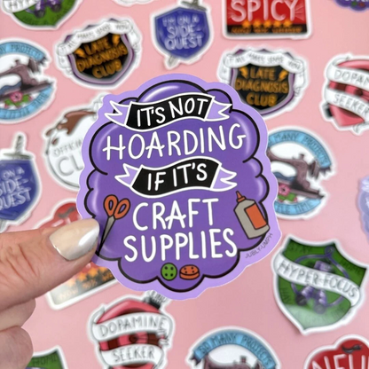 Sticker with 'It's not hoarding if it's craft supplies' text held over a pink background with various other . Sticker_Jubly_Umph_its_not_hoarding_sticker_sticker_backgroundstickers.