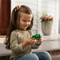 Tomy_simpl_dimpl_tractor_Child_sitting_and_playing_with_fidget