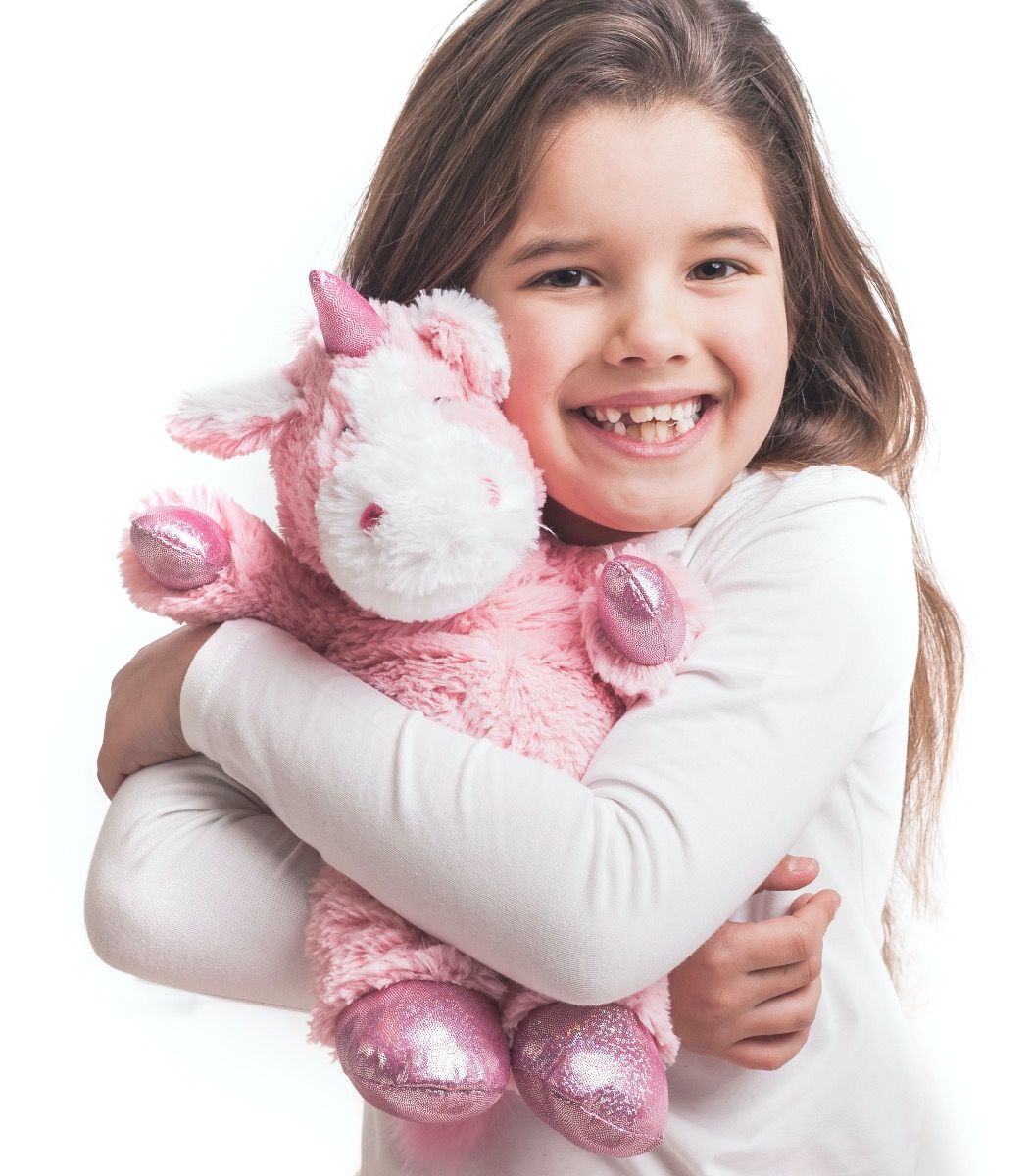 Warmies_pink_unicorn_being_cuddled_by_young_girl