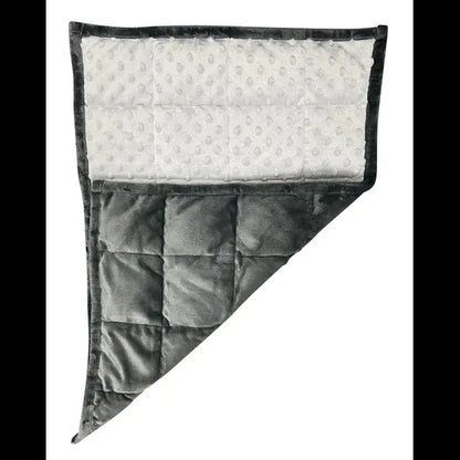Gray quilted blanket with white polka dot interior on a white background. Weighted_Lap_Pad_soft_grey_elizabeth_richards_contrast