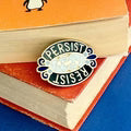 jUBLY_Umph_resist_persist_lapel_pin_book
