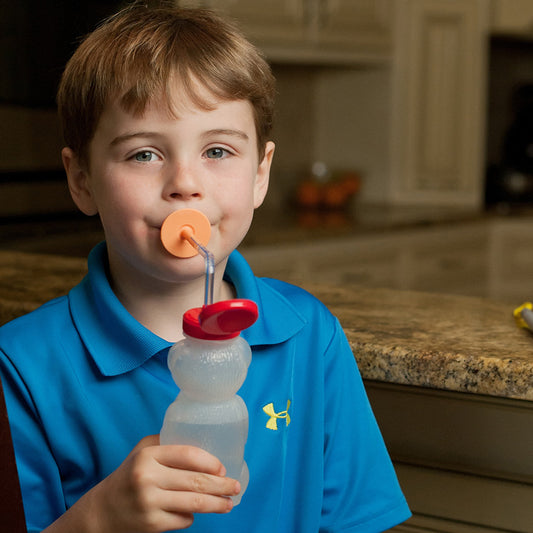 Boy_drinking_through_ARK'S_LIP BLOK_MOUTHPIECE_orange