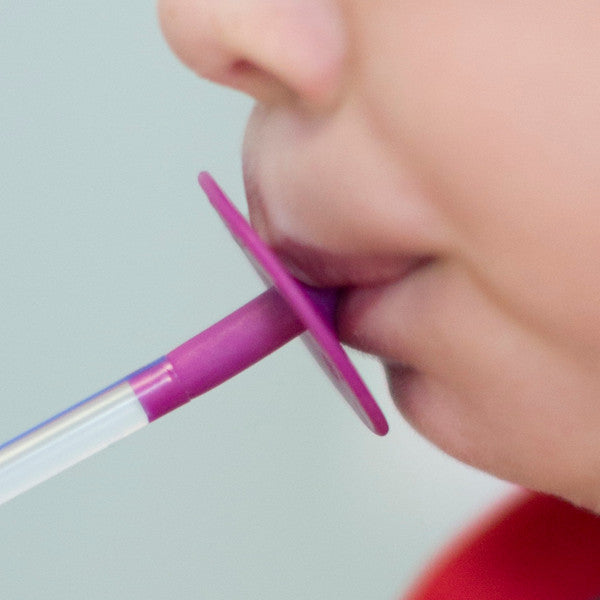 Close_up_childs_mouth_drinking_using_ARK'S_LIP_BLOK_MOUTHPIECE_magenta