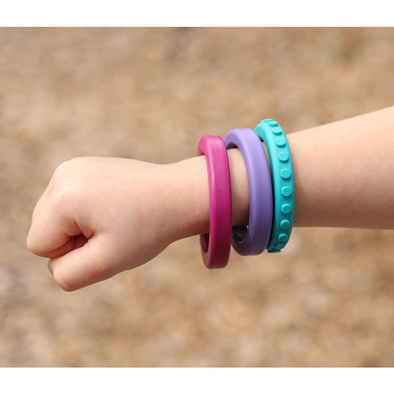 ARK'S_Brick_Bracelet_chewable_bangle_wrist_wearing_three_colourful_bracelets