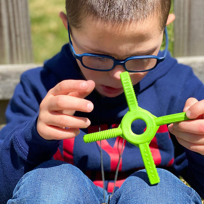 boy_studying_playing_with_Ark_tetra_bite_chewy_fidget_lime