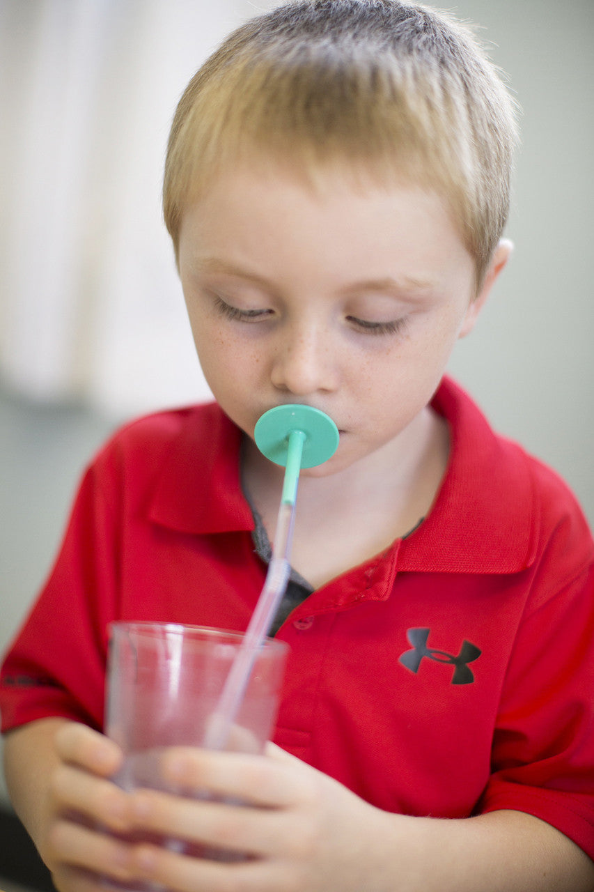 Boy_drinking_from_cup_through_a_straw_using_ARK'S_LIP_BLOK_MOUTHPIECE 