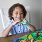 Child_using_dinosaur_cutlery_and_matching_plate_to_eat